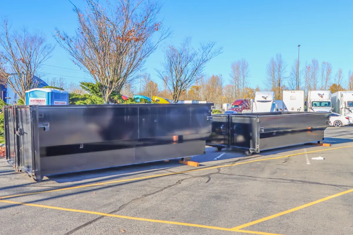 Professional dumpster rental service with roll-off container on residential driveway in Alton